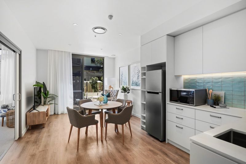 Rare upper level apartment with stunning Northern views over the bowling green.