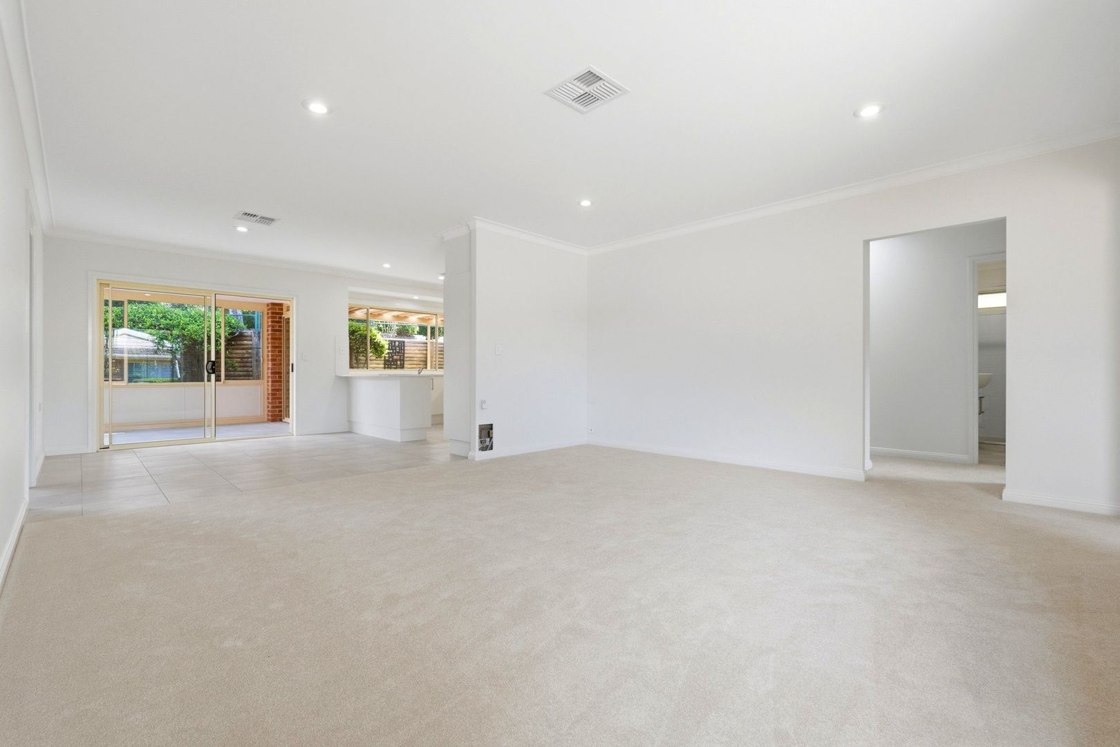 East facing rear aspect with enclosed sunroom and patio area for entertaining