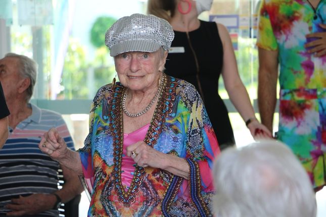 A resident gets into the groove at the Arcare Parkwood Mardi Gras event