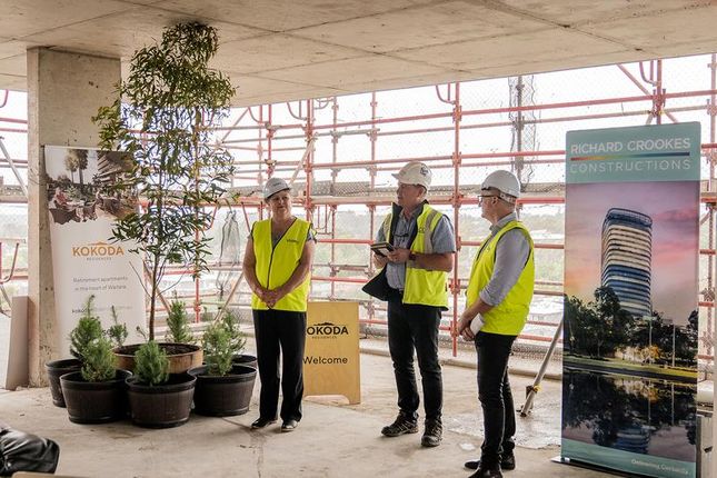 The Aleppo pine trees (left) at the topping out ceremony for the Kokoda Residences at Waitara