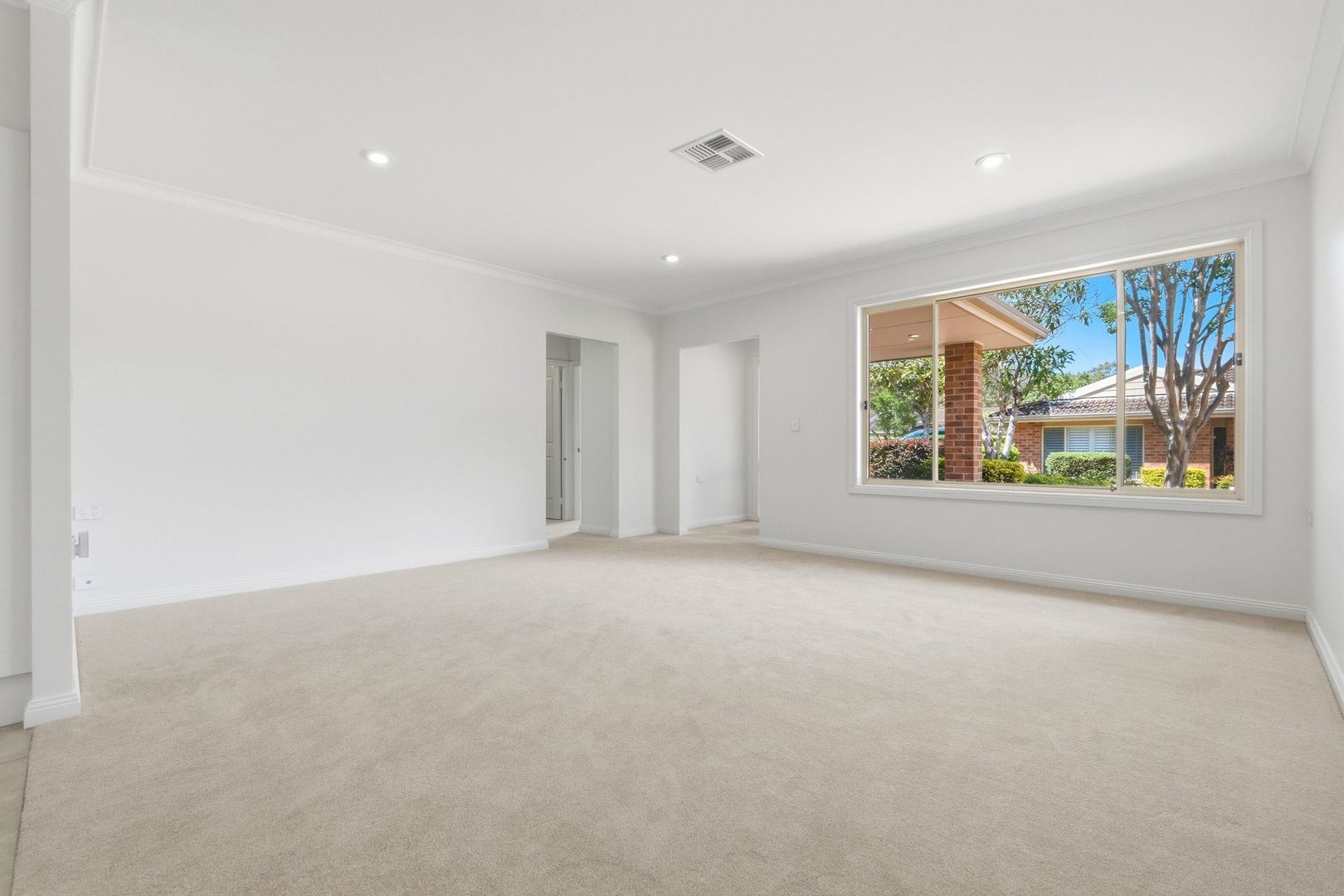 East facing rear aspect with enclosed sunroom and patio area for entertaining