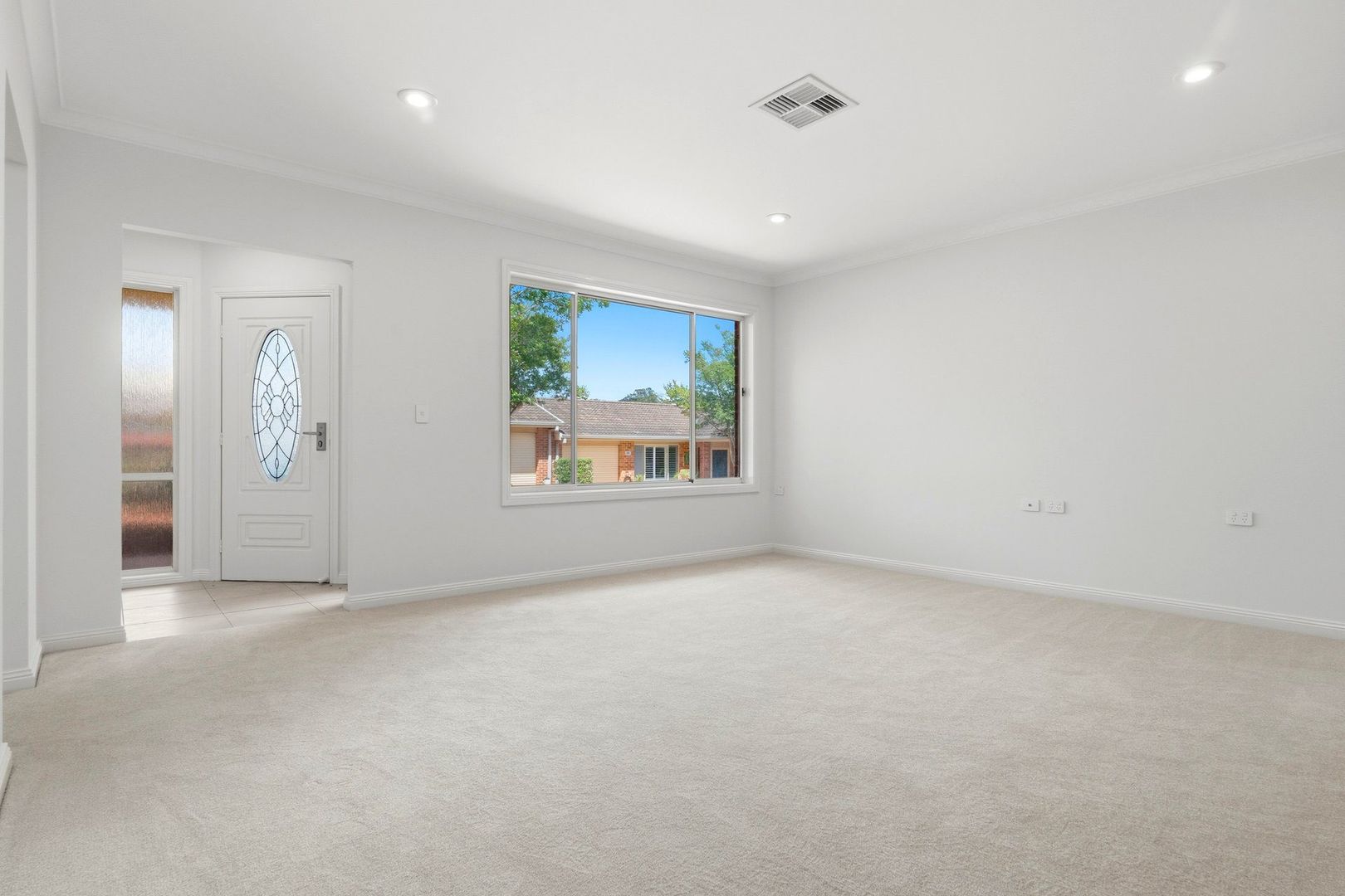 East facing rear aspect with enclosed sunroom and patio area for entertaining