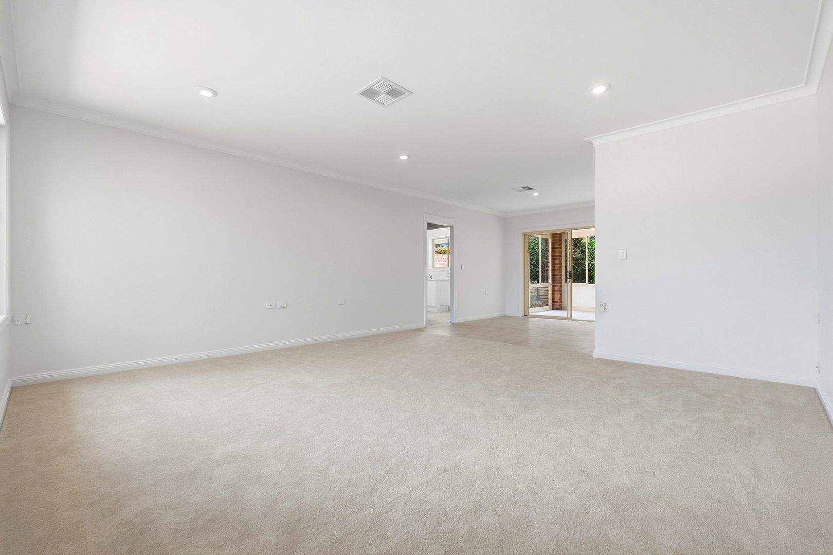 East facing rear aspect with enclosed sunroom and patio area for entertaining