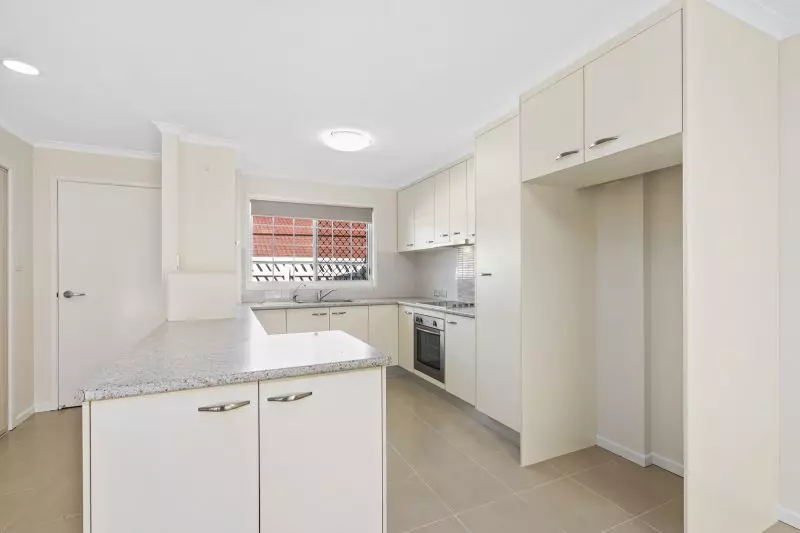 Beautiful two-bedroom, one bathroom villa with covered rear entertaining area.