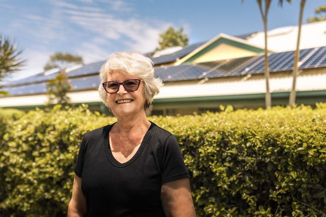 Eureka Wynnum resident Janette Redfern in front of the village's solar panels