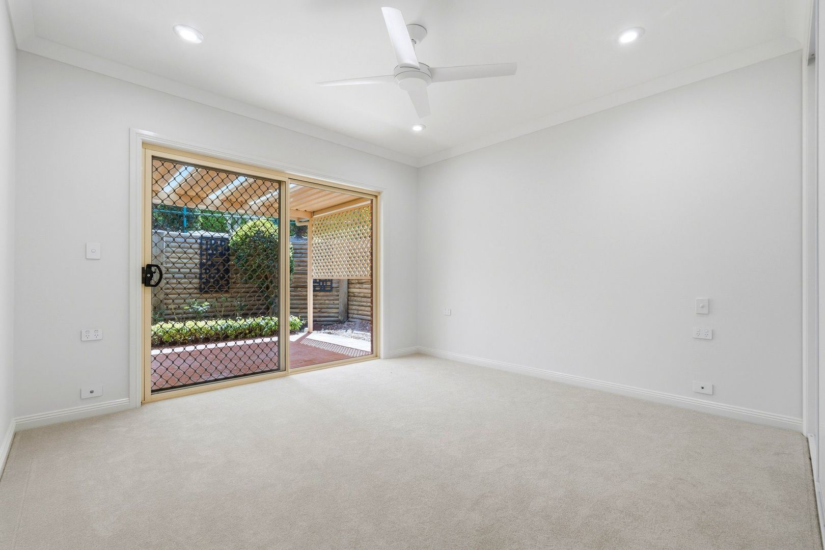 East facing rear aspect with enclosed sunroom and patio area for entertaining