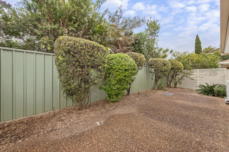 Level villa facing north to catch the winter sun with manicured grounds