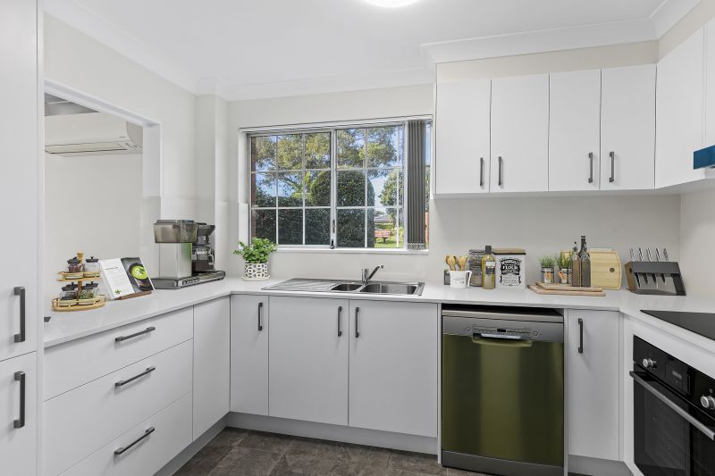 Centrally located, renovated ground floor unit surrounded by lush gardens with large courtyard.