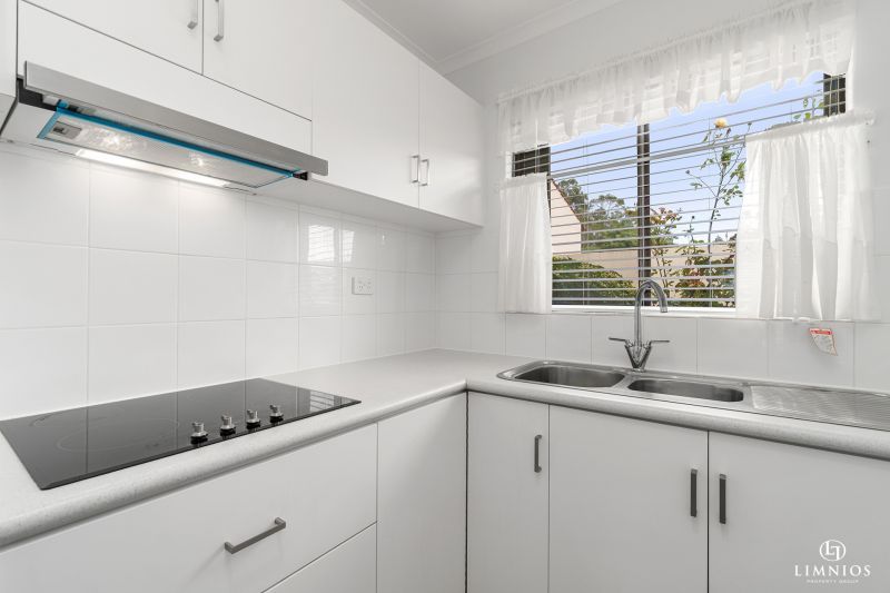 SOLD! A bright, light filled unit with a sunroom and leafy outlook