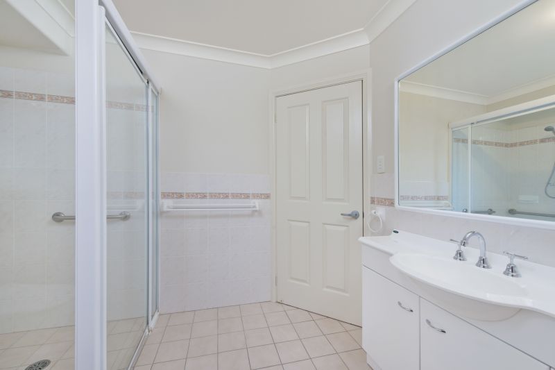 Level villa facing north to catch the winter sun with manicured grounds