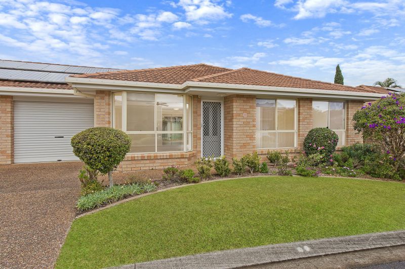 Level villa facing north to catch the winter sun with manicured grounds