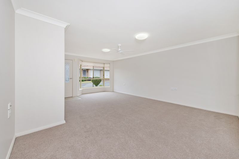 Level villa facing north to catch the winter sun with manicured grounds