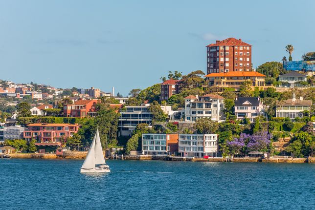 A yacht glides past the exclusive Sydney harbourside suburb of Point Piper