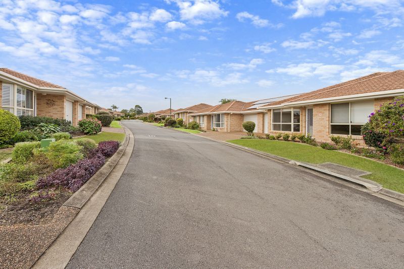 Level villa facing north to catch the winter sun with manicured grounds