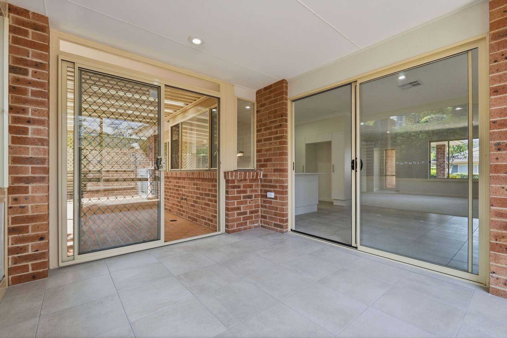 East facing rear aspect with enclosed sunroom and patio area for entertaining