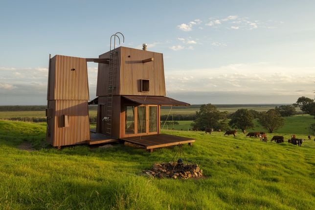The Permanent Camping Two home design blends into its rural landscape location